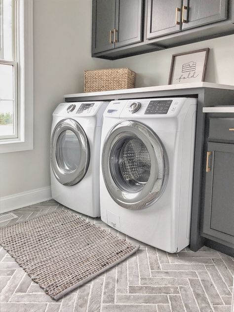 laundry room featuring herringbone brick-style porcelain tile and dark cabinets in Iron Ore by Sherwin Williams #laundryroom #herringbonetile #brickporcelaintile #bricktile #darkcabinets #IronOrebySherwinWilliams #interiordesign Room Tiles Floor, Laundry Room Tile, Laundry Room Design Ideas, Room Storage Diy, Dream Laundry Room, Laundry Room Flooring, Mudroom Ideas, Mudroom Laundry Room, Laundry Room Renovation