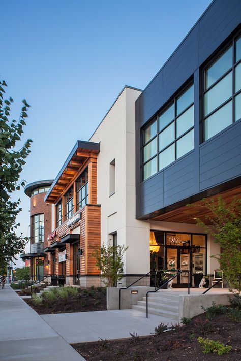 The Shoppes at Progress Ridge is a contemporary mixed-use development building that meets the neighborhood’s desire for an upscale shopping experience. Scott Edwards Architecture’s design is highly informed by a Pacific Northwest aesthetic and uses a contemporary blend of wood, stucco, masonry, steel, and glass to establish it as a high-quality commercial center. #architecture #commercialarchitecture #mixeduse #mixedusearchitecture #pacificnorthwestaesthetic Medical Building Exterior, Commercial Architecture Exterior, Contemporary Architecture Buildings, Pacific Northwest Architecture, Modern Commercial Building Exterior, Modern Warehouse Design Exterior, Modern Warehouse Design, Warehouse Design Exterior, Commercial Building Exterior