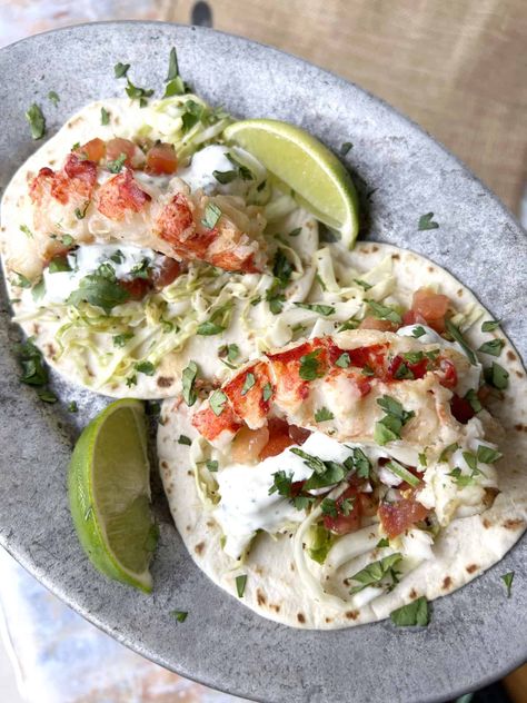 Talk about tacos with a premium twist! These Grilled Maine Lobster tacos will send your tastebuds soaring with a cilantro lime crema and delicious slaw. Cilantro Lime Crema, Maine Seafood, Lobster Tacos, Homemade Slaw, Grilled Lobster Tail, Lime Crema, Lobster Recipes Tail, Grilled Lobster, Fresh Lobster