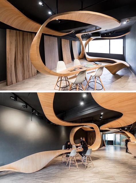 Studio Ardete has designed a ribbon-like sculptural wood installation for their client who sells veneers and plywood. #Wood #Design #RetailDesign Wood Installation, Wood Element, مركز ثقافي, Commercial Interior Design, Office Interior Design, Commercial Design, Commercial Interiors, Architecture Model, Retail Design