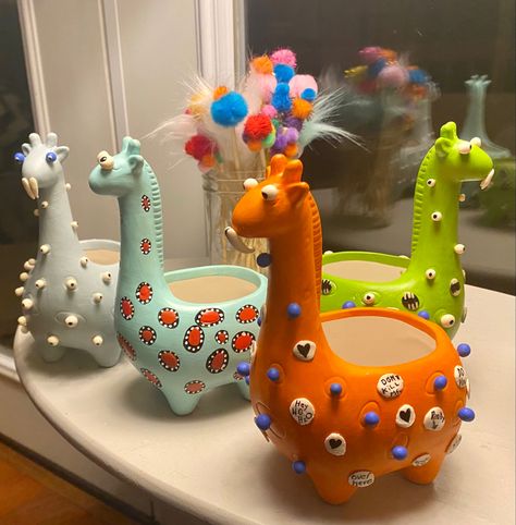 Fun little planters with polymer clay eyes teeth and mouths. Paper Mache Planter, Giraffe Clay Pot, Pot Heads Planters Fun, Planter Painting, Clay Plant Creatures, Clay Eyes, Animal Pots For Plants, Return Gifts For Kids, Paper Mache Christmas