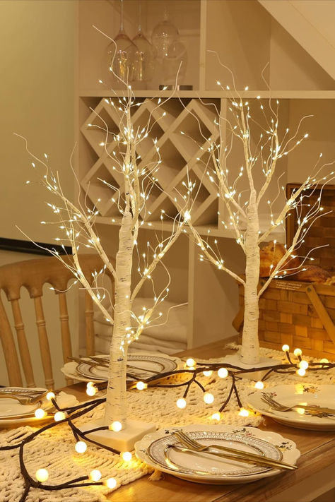 The silver birch branches, adorned with delicate twinkling lights and nestled amidst festive greenery, create a simple yet enchanting Christmas table centerpiece, exuding a touch of natural beauty and holiday warmth. This post contains an affiliate link which adds no cost to you. Wedding Indoor Decor, Birch Tree With Lights, Branch Table Centerpieces, Led Birch Tree, Branch Lights, Christmas Table Centerpiece, Tree With Lights, Wedding Indoor, Lights Decor