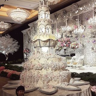 Image may contain: 1 person, table and indoor Quince Cake, Fancy Wedding Cakes, Huge Cake, Extravagant Wedding Cakes, Royal Cakes, Big Wedding Cakes, Quinceanera Cakes, Princess Birthday Cake, Extravagant Wedding