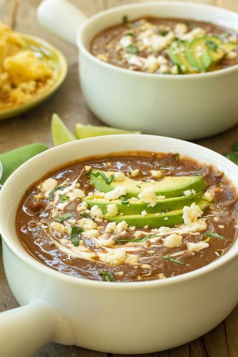 two white bowls filled with black bean and chorizo soup garnished with green avocado slices, crumbles of queso fresco, and swirls of crema Black Bean Corn Chorizo Soup, Chorizo Bean Soup, Black Bean Chorizo Soup, Chorizo Black Bean, Quick And Easy Soup Recipes, Chorizo Soup Recipes, Dinner Soup Recipes, Soup Night, Chorizo Soup