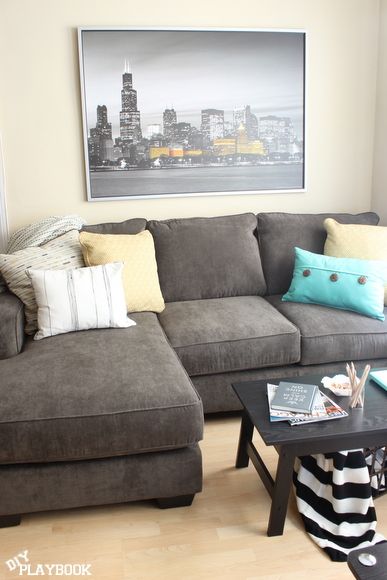 Dark gray couch with yellow and blue accents Dark Gray Couch, Grey Carpet Living Room, Gray Couch, Grey Couch, Grey Couch Living Room, Simple Pop, Spring Yellow, Diy Playbook, Apartment Life