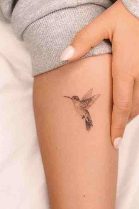 Tiny But Mighty - Hummingbird Tattoo Guide (70+ Examples!) - Tattoo Stylist Humming Bird And Flower Wrist Tattoo, Fineline Tattoo Hummingbird, Hummingbird Daffodil Tattoo, Hummingbird Tattoo Meaning For Women, Hummingbird Tattoo Ear, Hummingbird Sketch Tattoo, Hummingbird Tiny Tattoo, Hummingbird Feeder Tattoo, Hummingbird Wings Tattoo