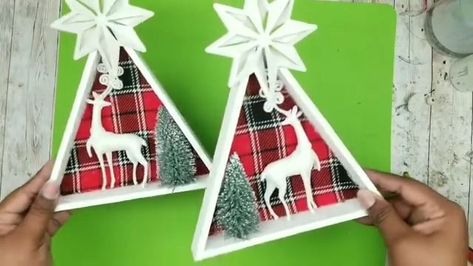 12K views · 355 reactions | Holiday Frame DIY | These Dollar Tree frames & ornaments make such cute crafts for Christmas holidays! ❤ | By She So CraftDee | Need two of these triangle frames from the Dollar Tree. I'm going to need a pack of these cobblestone winter trees from the Dollar Tree and one of these two packs of deer ornaments from the Dollar Tree. So, we're going to grab our triangular frames first and I wanted to paint everything that's a wood trim with white and I'm going to be using some acrylic white paint. You can definitely use chalk paint too if you like. So, I'm just starting on the inside and you don't have to be perfect here. You can get it on that printed part because we're going to be covering that up in the end. So, once you do the inside, you want to do the outside a Dollar Tree Sled Ornament, Dollar Tree Triangle Frame Christmas, Dollar Tree Santa Cam, Dollar Tree Faux Tin Tile Christmas Tree, Snowflake Made From Dollar Tree Christmas Trees, Crafts For Christmas, Dollar Tree Frames, Deer Ornament, Christmas Shadow Boxes