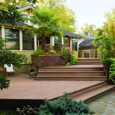 This home's floor sits 3½ feet above ground, so the deck needed to provide a gradual descent into the garden.    Seven steps connect the deck's three levels to a small ground-level patio with a portable fireplace.    There's seating on the top and bottom levels, and storage beneath the deck for the couple's canoes. Multi Level Deck, Tiered Deck, Deck Projects, House Deck, Deck Plans, Decks Backyard, Diy Deck, Backyard Deck, Exterior Ideas