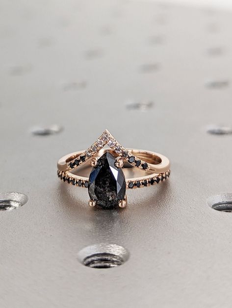 1.25 Carat 1920's Raw Salt and Pepper Diamond, Pear Diamond Ring, Unique Engagement Bridal Set, Black, Gray Pear 14k Yellow, Rose White Gold --- Pictures show the 14K Rose Gold with 1.25ct option --- Enchanting vintage inspired design, with a unique pear shaped full cut salt and pepper diamond, adorned with natural round brilliant diamonds on the band, can match with a unique Ombre diamond band. Piece Info: - Width : ~1.4mm - Side Diamonds : ~0.1ct - Comfort Fit  - Hypoallergenic, Cobalt-Free  - Black Diamond And Gold Engagement Ring, Black Pear Shaped Diamond Ring, Pear Shape Black Diamond Ring, Black Diamond Engagement Ring Pear, Black Diamond Engagement Ring Rose Gold, Dark Diamond Engagement Ring, Black And White Wedding Rings, Gold Salt And Pepper Engagement Ring, Black Diamond Pear Engagement Ring