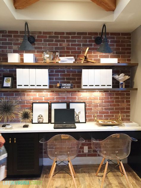 Omaha Street of Dreams Upstairs Desk Area - Life On Virginia Street Office Angled Ceiling, Office Ideas With Brick Wall, Brick Wall Home Office, Brick Wall Office Design, Brick Accent Wall Office, Office With Brick Wall, Office Wall Lighting, Office Brick Wall, Brick Office Space