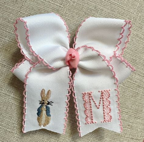 This listing is for 1 embroidered Easter moonstitch hair bow with embroidered initial and Peter Rabbit. The medium bow measures approximately 4 inches wide and is made from 1.5 inch moonstitch grosgrain ribbon. The large bow measures approximately 5.5 inches wide and is made from 2.25 inch moonstitch grosgrain ribbon. Bows will be attached to an alligator clip unless otherwise requested. This bow will complete your girl's Easter outfits! The moonstitch ribbon adds a unique and delicate touch! However, if you prefer the deigns on a non-moonstitch ribbon, then feel free to select a solid ribbon color! Indicate the following preferences for each hair bow in the personalization box (or notes section at checkout):  1. Ribbon Color (include moonstitch color) 2. Center Knot Color 3. Initial  4. T Monogrammed Hair Bows, Painted Hair Bows, Monogram Bow, Southern Baby, Easter Outfit For Girls, Easter Bows, Grosgrain Ribbon Bows, Embroidered Initials, Custom Easter