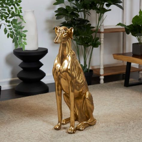 "Buy the 32\" Gold Dog Sitting Greyhound Sculpture at Michaels. com. The sitting greyhound statue has a gold satin finish that highlights the contour of this realistic dog sculpture. Make a bold statement and add a unique conversation piece when you place this gold dog sculpture in an entryway or living room corner next to a modern console or floor plant. Designed with a free-spirited charm this modern animal statue is crafted with solid resin for a sturdy and dynamic home décor piece. The sitti Greyhound Sculpture, Greyhound Statues, Villa Ideas, Dwelling Place, Living Room Corner, Floor Plants, Room Corner, Bedroom Idea, Grey Hound Dog