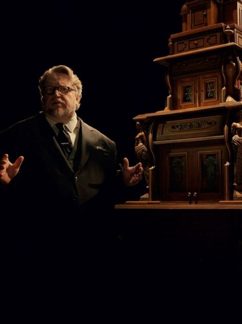 Guillermo del Toro is dressed in a grey suit, arms open, standing beside an ornate wooden cabinet as he explains his Cabinet of Curiosities Mike Flanagan, Cabinet Of Curiosities, New Netflix, Diving, Podcast, Historical Figures, Fictional Characters