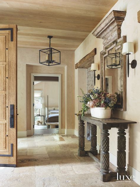 The entry door, made with fumed oak from reclaimed French barrels, was designed by Michner and crafted by HBB Studio in Portland, Oregon. The foyer area also features pieces selected by Deichl, including a Tripoli mirror hanging above a Dollie console, both by Formations from Shears & Window. The Gregorius Pineo pendant is from Kneedler-Fauchere. Bronze Tile Backsplash, Bronze Tiles, Italian Living Room, Rest And Recharge, Italian Country, Freestanding Tub Filler, Italian Interior, 3d Interior Design, Entry Hallway