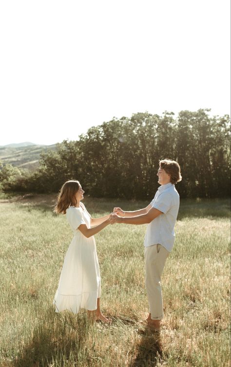 White Sundress Engagement Photos, Iowa Engagement Photos, Spring Engagement Shoot, Casual Engagement Photo Outfits, Floral Engagement Photos, Open Field Engagement Pictures, Wildflower Engagement Photos, Engagement Picture Dress, Spring Couples Photoshoot