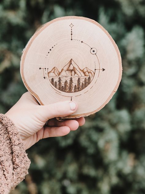 Wood burned mountain range on a birch wood round Burning Mountain, Mountain Hat, Wood Rounds, Exciting News, Mountain Range, Wooden Jewelry, Birch Wood, Wood Burning, Hand Lettering