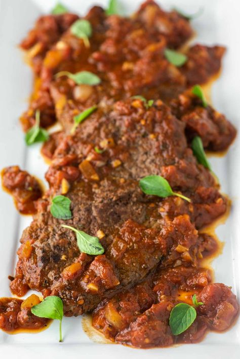 This steak pizzaiola consists of tender beef cooked in a garlicky tomato sauce, making it an easy but tasty dish. #steakpizzaiola #steak #italian | chiselandfork.com Beefsteak Tomato Sauce, Steak With Cherry Tomatoes, Slow Cooker Steak Pizzaiola, Authentic Italian Steak Pizzaiola, Steak Pizzaiola, Italian Sauce Recipes, Sirloin Tip Steak, Garlic Mashed Cauliflower, Traditional Italian Dishes