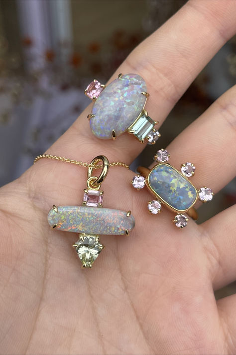 Hand wearing two yellow-gold rings and a pendant with large opal primary stones as well as a smaller sapphires in pinks and pale greens. Last Christmas Movie, Precious Opal, Inspo Board, Last Christmas, Christmas Movie, Funky Jewelry, Australian Opal, Jewellery Design, Magpie