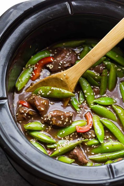 This super saucy slow cooker sesame ginger beef is topped with crisp snap peas for an easy take-out alternative! Perfect for an easy weeknight dinner. Sesame Ginger Beef, Healthy Soy Sauce, Snap Peas Recipe, Sesame Beef, New Chicken Recipes, Crock Pot Beef, Ginger Beef, Slow Cooker Recipes Beef, Sesame Ginger