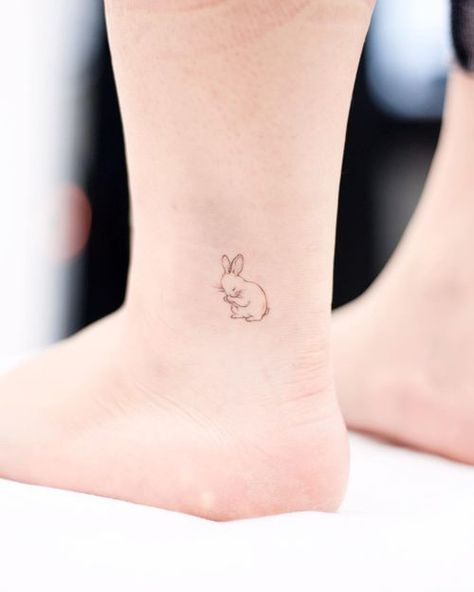 Ankle Tattoos: The Definitive Inspiration Guide • Tattoodo Bunny Tattoo Small, Hase Tattoos, Serotonin Tattoo, Ankle Band Tattoo, Cute Animal Tattoos, Bunny Tattoo, Ankle Tattoo Designs, Anklet Tattoos, Bunny Tattoos