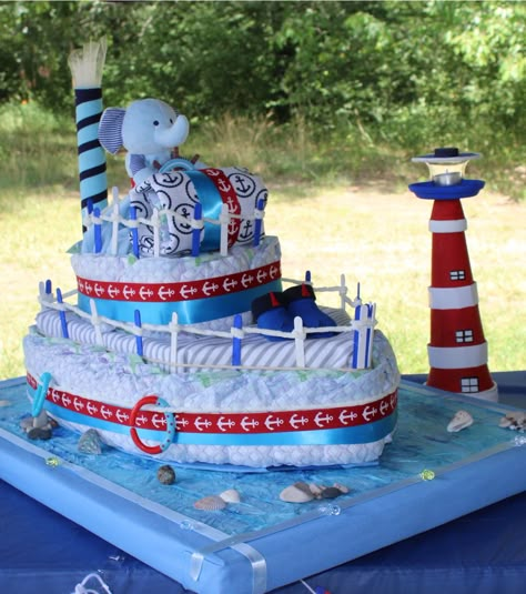 #Nautical theme #Diaper cake #blue #red #NauticalBabyShower #Itsaboy #lighthouse #seabase #elephantcaptain #seashells #stones Baby Shower Nappy Cake, Boat Diaper Cake, Unique Diaper Cakes, Diaper Gifts, Idee Babyshower, Baby Shower Baskets, Baby Shower Crafts, Baby Shower Diaper Cake