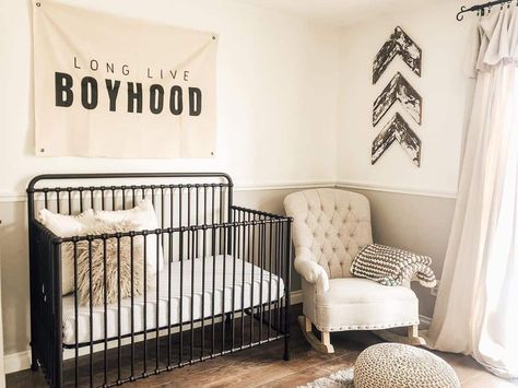 28 Charming Nursery Theme Ideas To Welcome Baby Metal Crib Nursery, Black Metal Crib, Black And Beige Decor, Gray Wainscoting, Nursery Theme Ideas, Tufted Rocking Chair, Metal Crib, Beige Decor, Baby Boy Room