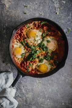 Shakshuka with Zhoug, a spicy green sauce made with aromatic herbs, originated from Yemen #breakfast #vegetarian | TheAwesomeGreen.com Breakfast Around The World, Shakshuka Recipes, Light Bites, Tomato Recipes, Healthy Vegetarian, Yemen, Egg Recipes, Flatbread, Fresh Herbs