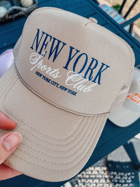 Show of your style in our New York Sports Club trucker hat.- Features the phrase "New York Sports Club" with "New York City, New York" underneath in navy and white ink- Individually heat pressed onto each hat- 5 Panel, Mesh Back with Snap Back*due to screens & filters colors may vary slightly to photos* New York Cap, Modern Hat, Hipster Tshirts, Sports Club, Cap Designs, Hat Patches, Hat Ideas, City New York, Sport Hat