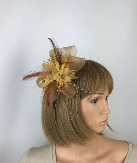 A pretty sandy gold fascinator to compliment an outfit for a wedding, mother of the bride or guest, a day at the races, a tea party, bbq, dinner dance or a memorable occasion, garden parties, hen night, etc Striking fascinator complemented by beautiful beads and feathers. This fascinator is made from quality gold crin and is worn via a metal clip so is comfortable to wear. Can also be worn as a corsage due to the brooch pin. Approximate size of fascinator is 14-16 cm approx in diameter (excludin Gold Fascinator, Ascot Ladies Day, Red Fascinator, Bbq Dinner, Occasion Hats, Hat Wedding, Hen Night, Wedding Fascinators, Champagne Wedding