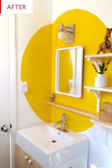 This bathroom makeover only cost $130. We love the new shelving, mirror and especially the unique paint color and design. This is proof that you can transform your bathroom on a budget. Interesting Bedroom Walls, Colour Blocking Bathroom, Colorful Bathroom Paint Ideas, Colorful Entryway Ideas, Yellow Bathroom Paint, Colorful Bathroom Ideas, Colorful Bathroom Decor, Unique Paint Colors, Bathroom Mural