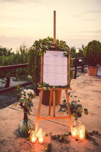 Seating plan displayed with a natural wooden frame on a rustic wooden easel, decorated with foliage, Mallorcan vases with loose flowers and cylindrical vases with chunky candles.  Terrace at Son Marroig, at the entrance to the dinner area. Natural Wedding Flowers, Mallorca Wedding, Photo Corner, Wedding Mirror, Artist Easel, Wooden Easel, Wedding Entrance, Art Easel, Bridal Shower Welcome Sign