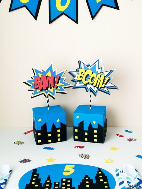 Superhero/Comic Book Table Decoration and Comic Book Sign. Adding those extra touches to your little ones party tables will WOW your guests and will be great to keep after the party celebrations are complete. All handmade using quality card stock. Comes already assembled, simply place Superhero Comic Book, Godzilla Birthday, Superman Party, Marvel Birthday Party, Pj Masks Birthday Party, Superman Birthday, Pj Masks Birthday, Spiderman Birthday Party, Avengers Party