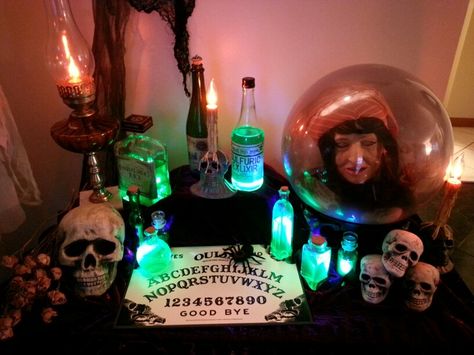 Halloween fortune teller table with glowing potion bottles. Halloween diy.  Design by Marc P. Fortune Teller Table Halloween, Fortune Teller Cubicle, Fortune Teller Room Decor, Fortune Teller Table Decorations, Halloween Fortune Teller Decor, Fortune Teller Halloween Decorations, Fortune Teller Decorations, Fortune Teller Decorations Ideas, Glowing Potion Bottles