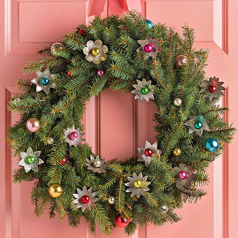 Flower-Studded Wreath Give mini Christmas balls a little extra oomph by placing them in the center of vintage tree light reflectors. Attach the ultrashiny ornaments and additional balls to the wreath using florist's wire, then hang with a ribbon in an unexpected color, such as dusty pink or mint green. Homemade Christmas Wreaths, Holiday Diy Projects, Creative Wreaths, Homemade Wreaths, Holiday Mantel, Pink Christmas Decorations, Christmas Wreaths To Make, Pink Christmas Tree, Pretty Christmas