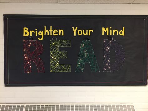 Brighten your mind READ library bulletin board with string art and pixie lights. December 2016 Bulletin Board Ideas With Light Bulbs, Reading Lights Up The Mind Bulletin Board, Today A Reader Tomorrow A Leader Bulletin Board, Readers Are Leaders Bulletin Board, Growing Readers Bulletin Board, Art Bulletin Boards, Library Bulletin Board, Reading Bulletin Boards, School Library Displays