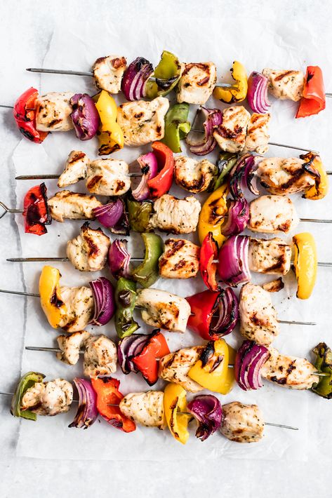 Grilled Greek chicken kabobs made with a yummy, zesty greek marinade, red onion, three different types of bell peppers, and served with a homemade greek yogurt tzatziki sauce! An easy meal to make on the grill. #chicken #chickenrecipe #kabobs #grilling #glutenfree #grainfree #paleorecipe #paleo #healthydinner Chicken Skewers In Oven, Greek Chicken Skewers, Chicken Shish Kabobs, Greek Chicken Kabobs, Chicken Kabob Recipes, Grilled Chicken Kabobs, Homemade Greek Yogurt, Homemade Tzatziki Sauce, Chicken Souvlaki