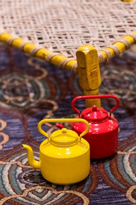 Photo of Red and yellow tea kettles in decor Wedding Decor Themes, Resturant Design, Tea Restaurant, Trending Images, Decoration Theme, Outdoor Restaurant Design, Restaurant Exterior, Coffee Shop Interior Design, Food Cart Design