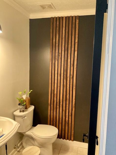 An easy project that can make a BIG impact! This slat accent wall is beginner friendly and can be completed in a day's time! Customize this slat wall to meet the look you are going for. BeforeThis is our half bathroom before I got the idea to add a little something. Was there anything wrong with this room? No. Could it use a little spunk to make it more interesting? Of course!I worked with the existing color scheme (in basically my whole house) of black, wood and green to create this… Small Slat Wall, Simple Bathroom Accent Wall, Wood Accent In Bathroom, Black And Wood Powder Room, Wood Slat Wall In Bathroom, Slat Accent Wall Bathroom, Modern Accent Wall Bathroom, Slatwall Bathroom, Slat Wall Powder Room