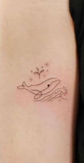 85 Magnificent Whale Tattoos, Ideas, & Meaning - Tattoo Me Now Cartoon Whale Tattoo, Jonah And The Whale Tattoo, Simple Pretty Tattoos, Tattoo Ideas Whale, Cute Whale Tattoo, Fine Line Fish Tattoo, Whale Tattoo Minimalist, Simple Whale Tattoo, Small Whale Tattoo