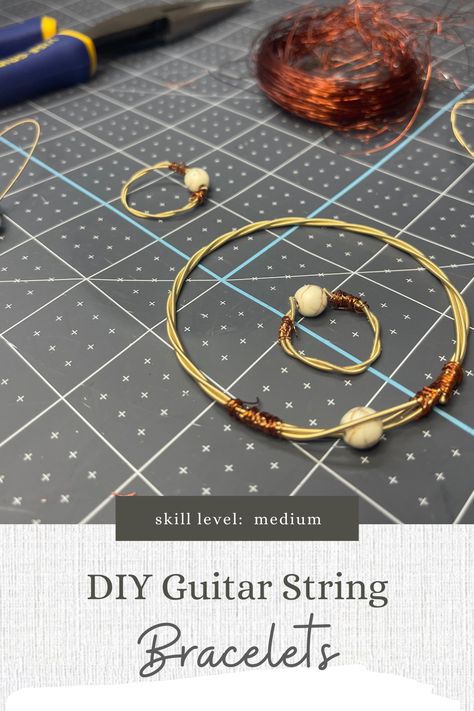 If you have an avid guitar player in your family, then you probably have watched them change the strings fairly often. You can purchase bracelets online, but have you ever thought of making your own? Here are some tips for those of you ready for this crafty upcycle project. Guitar String Jewelry, Guitar String Bracelet, Mountain Dulcimer, String Earrings, String Jewelry, Violin Strings, Diy Guitar, Wire Wrap Jewelry Designs, String Bracelets