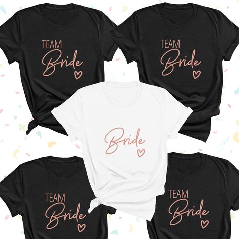 "These are a hand made item that takes 1-3 days to create. Introducing our beautiful new Rose Gold Team Bride T-Shirts. Our High Quality, Handmade, Custom Hen Party T-shirts will have you and your Bride Squad standing out on your Bachelorette Party. Ideal for wearing on your Hen weekend or party for the perfect photographs and selfies. These lovely personalised tops also make great gifts and favours. Our Team Bride Shirts are 100% Cotton and super soft to the touch.  Personalised Bride shirt and Bride Squad T-shirts, with the names and initials of your choice, these Bachelorette Party T-shirts will be a much loved keepsake of your special day.    Available in white and classic black with a choice of Gold, Silver, Rose Gold and White personalisation, these stylish Bride shirt are from our N Team Bride Shirts, Party T Shirts, Bride Shirt, Bridal Party Shirts, Personalized Bride, Clothing Gifts, Bride Squad, Bride Shirts, Bridesmaids Personalized