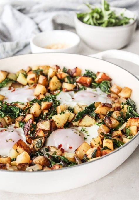 Spinach Arugula Breakfast Hash is a hearty way to start your day with crispy golden potatoes, plenty of greens, garlic, & fried eggs. Plus it's Whole30, dairy free, and gluten free!