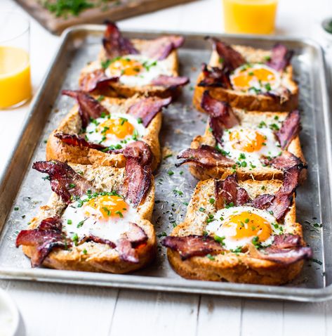 Sheet Pan Egg In A Hole - TableandDish Egg In A Hole Avocado Toast, Egg Hole Toast, Baked Egg In A Hole, Frog In A Hole Breakfast, Eggs In Toast Hole, Egg In Toast Hole Oven, Egg In The Basket, Egg In Hole Toast, Eggs In A Hole Recipe