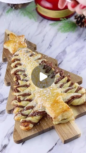 Sheri Wilson on Instagram: "Xmas Nutella Tree 🎄  So easy and delicious! I used Nutella but you can fill with your favorite spread!   You’ll need- -puff pastry  -Nutella  -one egg, beaten -powdered sugar  Place a sheet of puff pastry onto a piece of parchment paper and spread on a layer of Nutella. Place a second layer of puff pastry on top.  Cut the pastry into a triangle shape, leaving a small rectangle at the very bottom for the tree trunk.   Cut slits on each side of the triangle from the bottom all the way up to the top. Twist each of the slits.  Brush the tree with the egg wash mixture and bake according to package directions.  Dust with powdered sugar and serve warm!   #nutella #puffpastry #christmas #christmasbaking #baking #holidays #holidaybaking  #bakingfun #easybaking #snowflak Nutella Twists Puff Pastries, Holiday Recipies, Egg Wash, Powdered Sugar, Puff Pastry, Holiday Baking, Easy Baking, Christmas Baking, Baked Goods