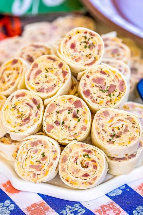 Ham & Cheese Pinwheels - I am ADDICTED to these sandwiches! All the flavors of my favorite Hot Party Ham Sandwiches wrapped in a tortilla.Cream cheese, ham, cheddar, swiss, Worcestershire sauce, dijon mustard, brown sugar, and onion powder wrapped in a tortilla. So simple to make. Can make ahead of time and refrigerate or freeze until ready to eat. Perfect for parties and tailgating!! #sandwich #tortilla #ham #cheese #appetizer #partyfood #tailgating Legoland Orlando, Easy Pinwheel Recipes, Pimento Cheese Pinwheels, Ham Appetizers, Recipes With Cream Cheese, Tortilla Rollups, Tortilla Pinwheels Recipe, Turkey Pinwheels, Chicken Pinwheels