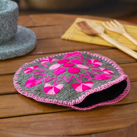 Enjoy traditional Mexican meals with perfectly heated tortillas from start to finish with the help of this felt tortilla holder that will keep them always warm and soft. Martha Lopez embellishes the grey holder with hand-embroidered cotton motifs of dots, fans and a sixteen-pointed star in a delightful blend of fuchsia, rose and pastel pink hues. This must-have serveware accessory is lined with cotton to ensure optimal freshness throughout your dining experience. Felt Tortilla, Tortilla Holder, Felt Skull, Pink Taco, Mexico Gift, Mexican Meals, Taco Time, Serveware Entertaining, Gift Suggestions