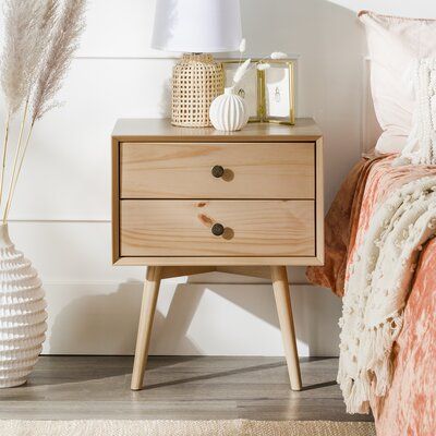 Looking for a side table that won’t weigh down your space? This mid-century modern nightstand made of beautifully stained pine and antique-finished metal hardware could be the one for you. With beveled front details, two-drawer storage, and its solid wood make-up, this piece is a triple threat of character, function, and durability. Made of wood responsibly harvested from renewable forests, this eco-friendly nightstand will allow your environmental conscience to sleep easier. Plus, assembly is a Mid Century Modern Nightstand, Mid Century Modern Aesthetic, Side Tables Bedroom, Drawer Knob, Redecorate Bedroom, 2 Drawer Nightstand, Modern Nightstand, Wood Nightstand, Triple Threat