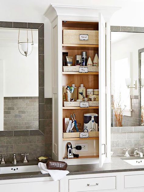 If more storage is a priority over expansive counter space in your bathroom, consider a storage tower. The unit makes use of vertical space between the sinks of a double vanity and provides easy-to-reach storage for both sink areas. For extra savvy functionality, include an outlet in the cabinet for razors, hair dryers, and more. Bathroom Storage Tower, Bathroom Countertop Storage, Makeover Kamar Mandi, Bathroom Vanity Storage, Bathroom Cabinet Organization, Bathroom Necessities, Creative Bathroom, Countertop Storage, Bad Inspiration