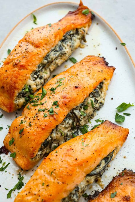 This spinach stuffed salmon is a flavor explosion, with the creamy richness of the cheese and the earthy goodness of the spinach perfectly complementing the tender, flaky salmon. It's a restaurant-quality meal that's ready in just 45 minutes! Stuffed Salmon Recipe, Spinach Stuffed Salmon, Stuffed Salmon, The Recipe Critic, Recipe Critic, Salmon Dinner, Easy Seafood Recipes, Incredible Recipes, Salmon Recipe