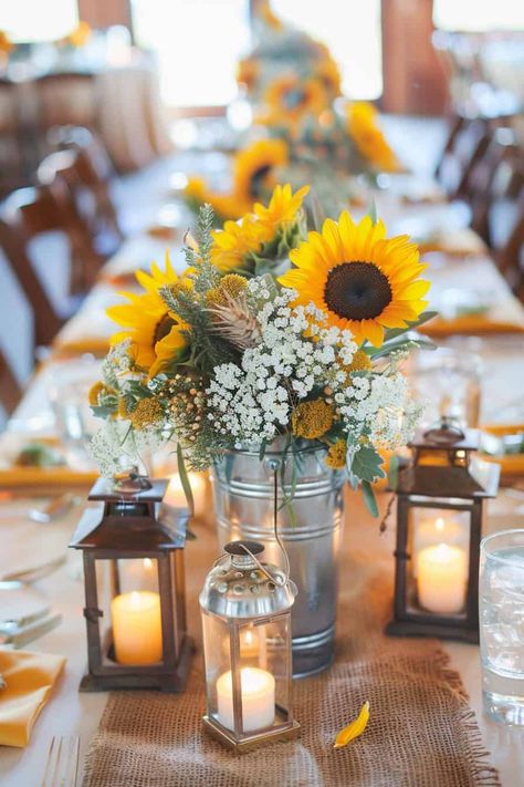 14 Sunflower Centerpiece Ideas For Weddings And Events • Sunflower Rehearsal Dinner Decorations, Sunflowers And Daisies Wedding, Mason Jar Photo Centerpieces, Diy Sunflower Centerpieces, Sunflower And Daisy Wedding, Sunflower Tablescapes, Boho Wedding Centerpieces Diy, Daisy Wedding Theme, Fall Sunflower Weddings